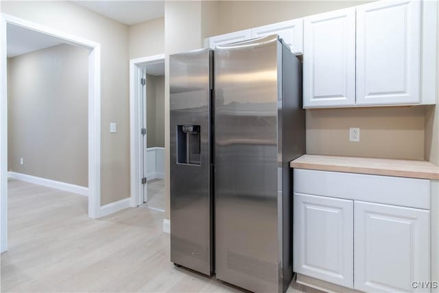 kitchen with white cabinetry, stainless steel fridge with ice dispenser, and light wood-type flooring