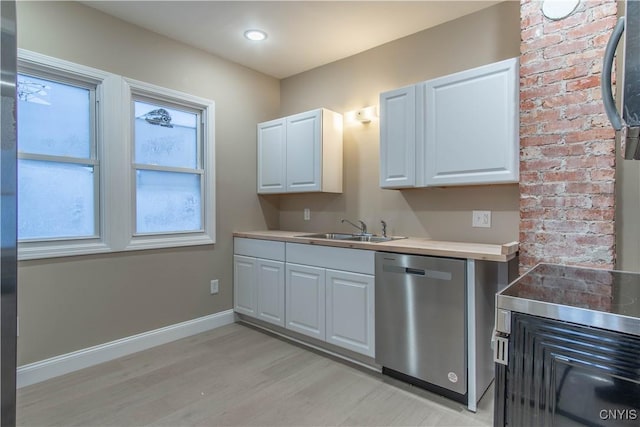 kitchen featuring white cabinets, dishwasher, light wood-type flooring, and sink