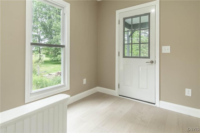 223 S Washington St, Wilna, NY 13619 - entryway featuring radiator heating unit and light wood-style floors