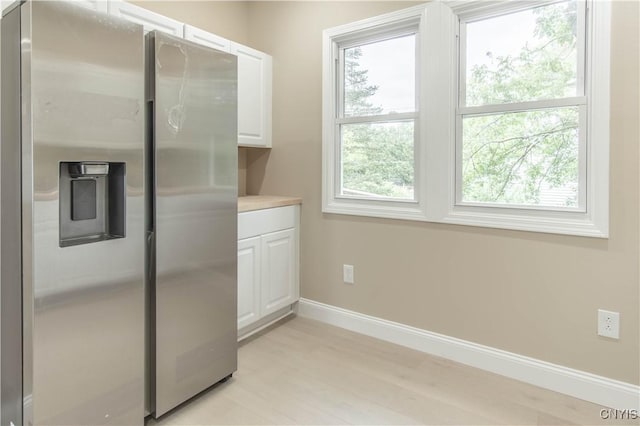 223 S Washington St, Wilna, NY 13619 - kitchen with stainless steel fridge with ice dispenser, white cabinetry, light countertops, and light wood-type flooring