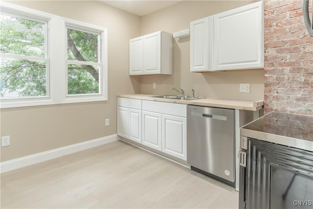 223 S Washington St, Wilna, NY 13619 - kitchen with stainless steel dishwasher, light wood finished floors, white cabinetry, and light countertops
