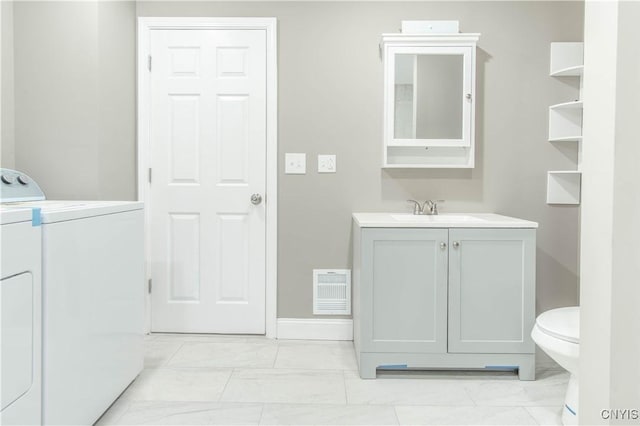 223 S Washington St, Wilna, NY 13619 - bathroom with washer and dryer, vanity, and marble look tiles
