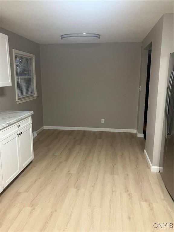 unfurnished dining area with light wood-type flooring