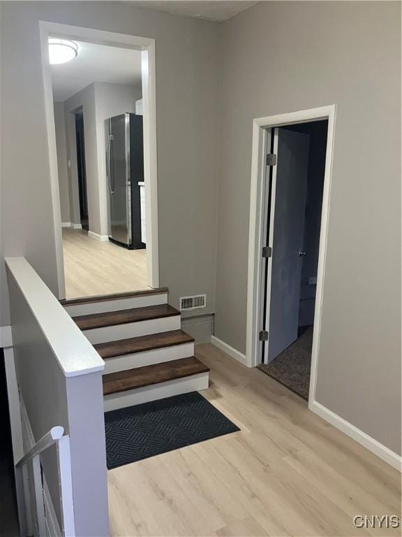 stairs featuring wood-type flooring