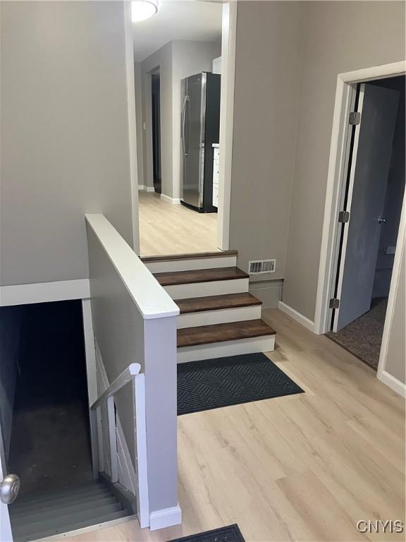 stairway featuring wood-type flooring