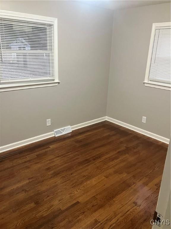 empty room featuring dark wood-type flooring