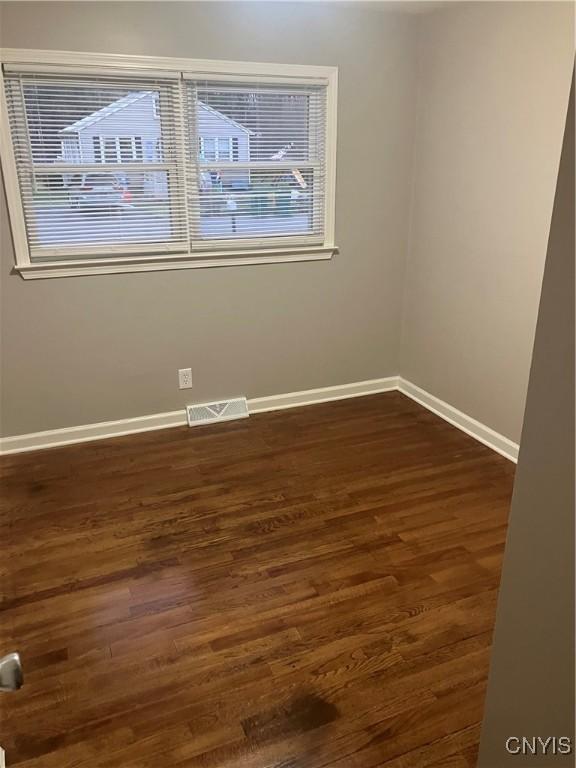 spare room featuring dark hardwood / wood-style floors