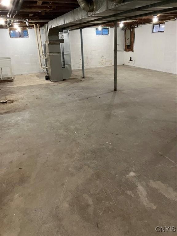 basement with heating unit and electric panel