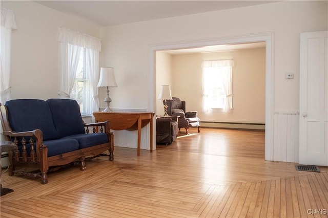 sitting room featuring a baseboard heating unit