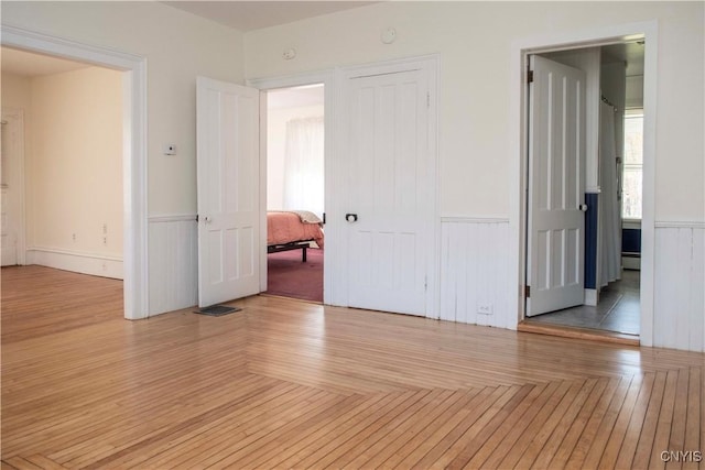 unfurnished room with light wood-type flooring