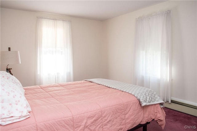 bedroom with carpet floors and baseboard heating