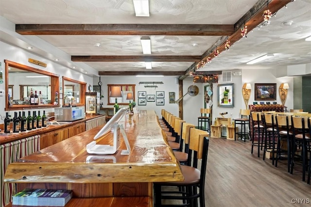 bar featuring hardwood / wood-style flooring and beamed ceiling