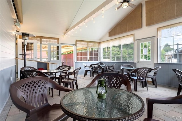 sunroom with plenty of natural light, ceiling fan, and vaulted ceiling