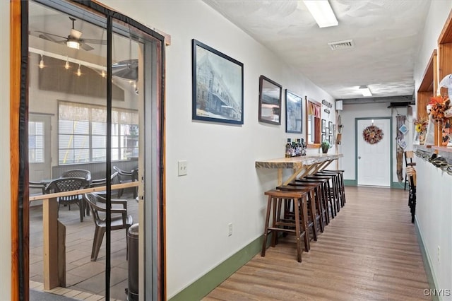 hallway with hardwood / wood-style floors