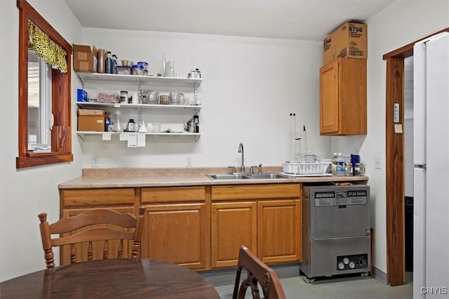 kitchen with dishwasher, white refrigerator, and sink