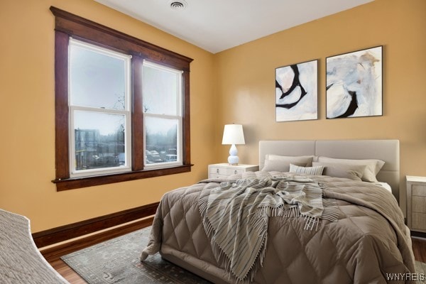 bedroom with hardwood / wood-style flooring