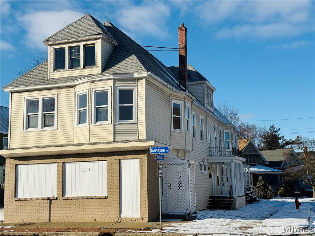 view of snowy exterior with a garage