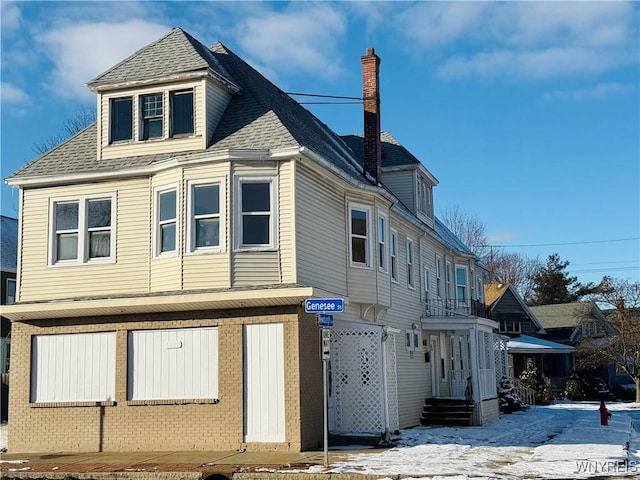 view of snowy exterior with a garage