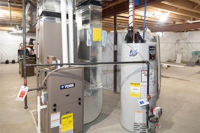 utility room with heating unit and water heater