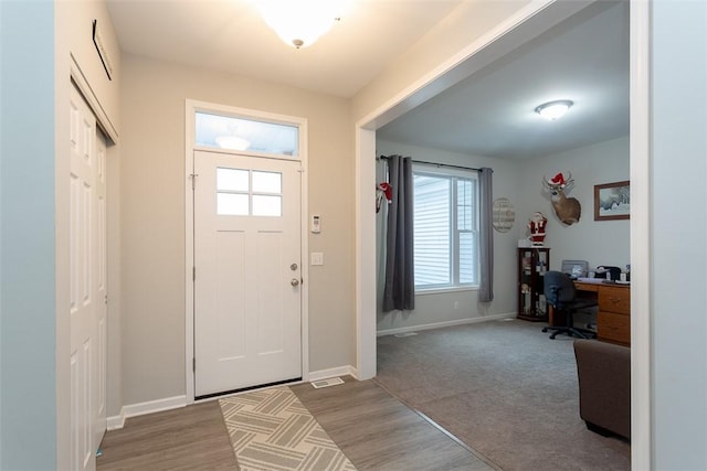 entrance foyer with hardwood / wood-style floors and a healthy amount of sunlight