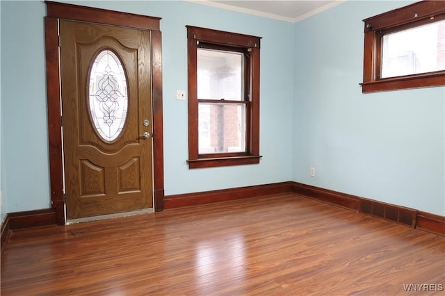 entryway featuring hardwood / wood-style floors and crown molding