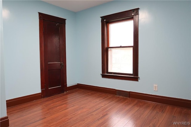 spare room featuring wood-type flooring