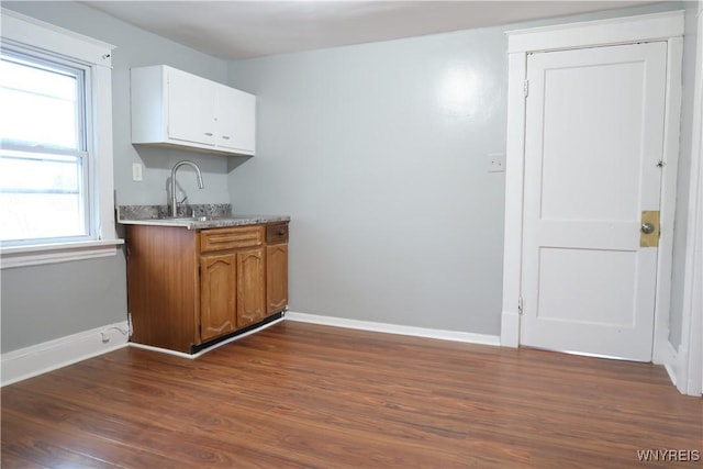 kitchen featuring dark hardwood / wood-style floors, white cabinetry, and sink