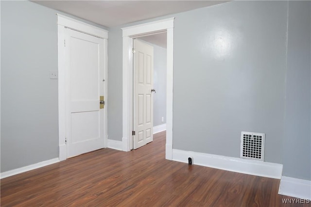 unfurnished room featuring dark hardwood / wood-style flooring