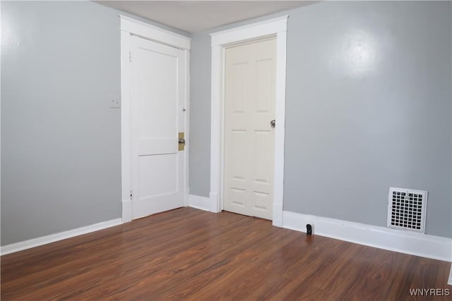 empty room with dark wood-type flooring