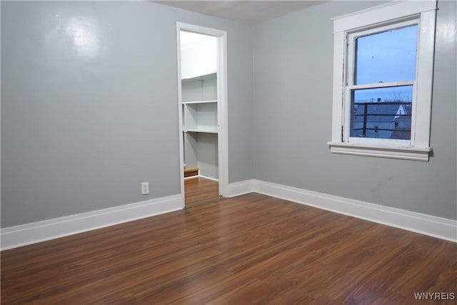 unfurnished room featuring dark hardwood / wood-style flooring