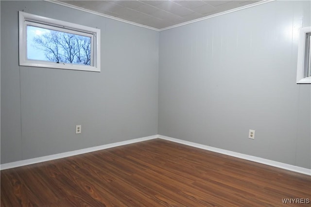 spare room with dark hardwood / wood-style floors and crown molding