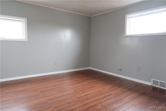 unfurnished room with dark hardwood / wood-style flooring and crown molding