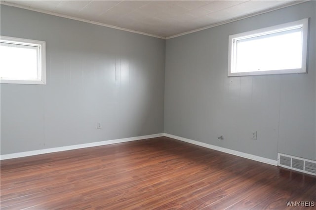 spare room with dark hardwood / wood-style flooring and ornamental molding