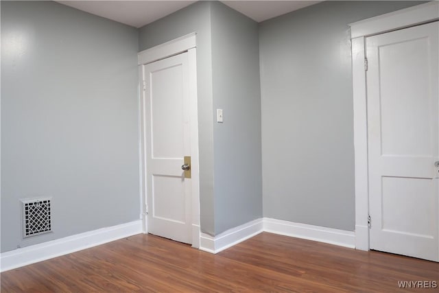 empty room with wood-type flooring