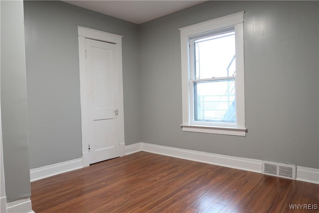 unfurnished room featuring dark hardwood / wood-style floors