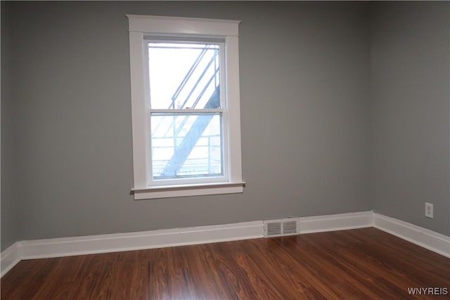 empty room featuring hardwood / wood-style floors and a wealth of natural light