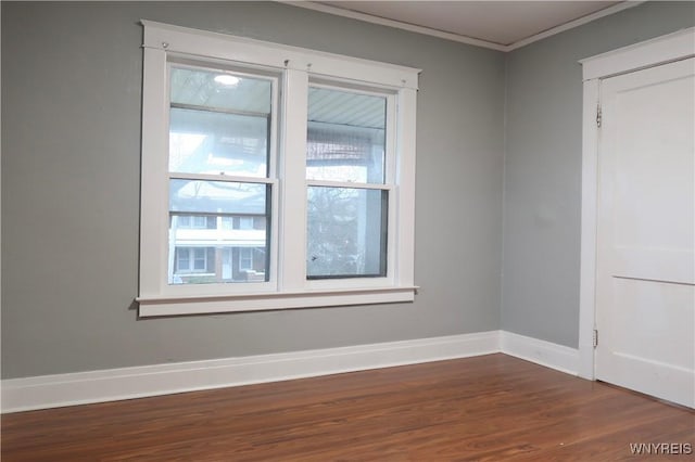 unfurnished room featuring dark hardwood / wood-style floors and crown molding