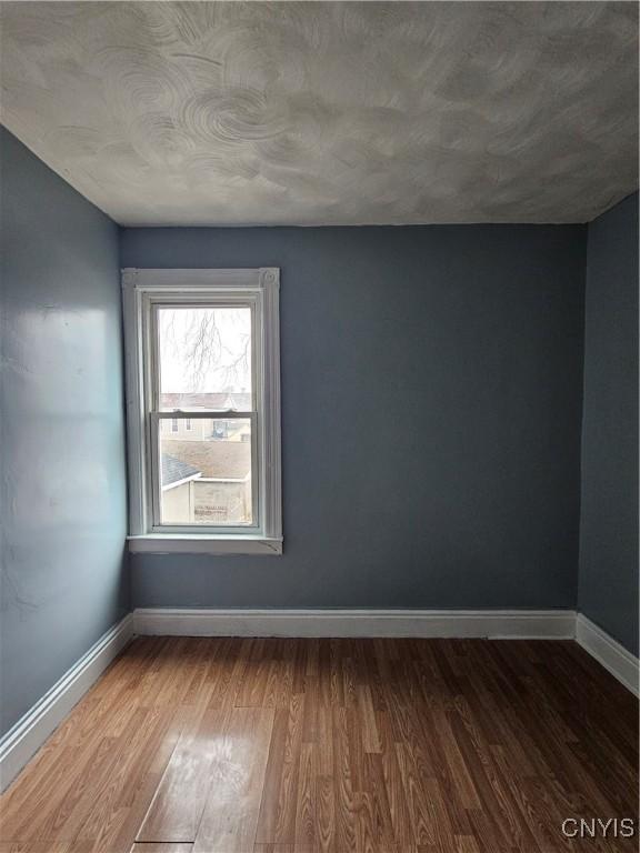 empty room with hardwood / wood-style floors