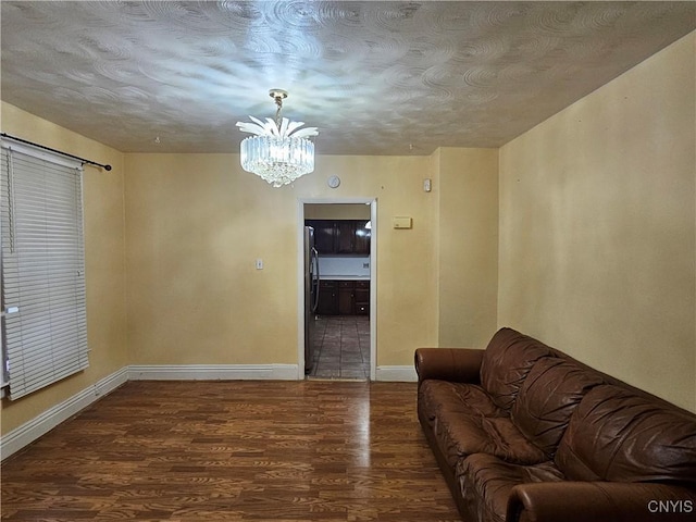 living room featuring wood-type flooring and an inviting chandelier