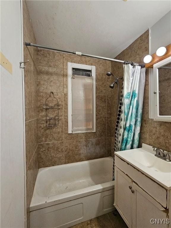 bathroom with vanity, shower / bath combo, and tile walls