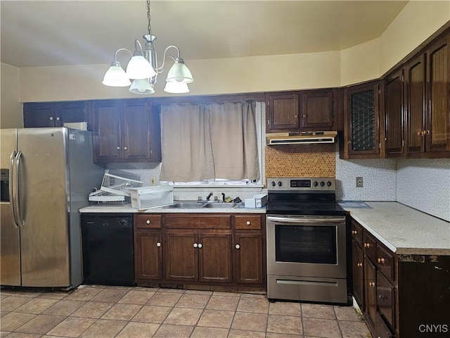 kitchen featuring appliances with stainless steel finishes, dark brown cabinetry, sink, decorative light fixtures, and a chandelier