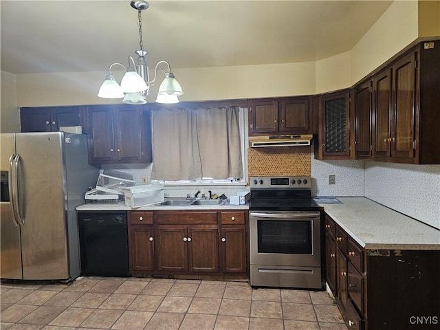 kitchen featuring appliances with stainless steel finishes, dark brown cabinetry, sink, pendant lighting, and an inviting chandelier