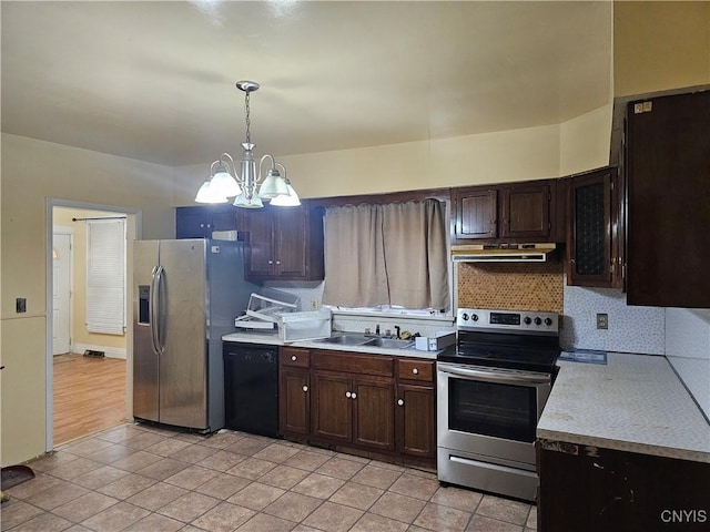 kitchen featuring a notable chandelier, dark brown cabinetry, hanging light fixtures, and appliances with stainless steel finishes