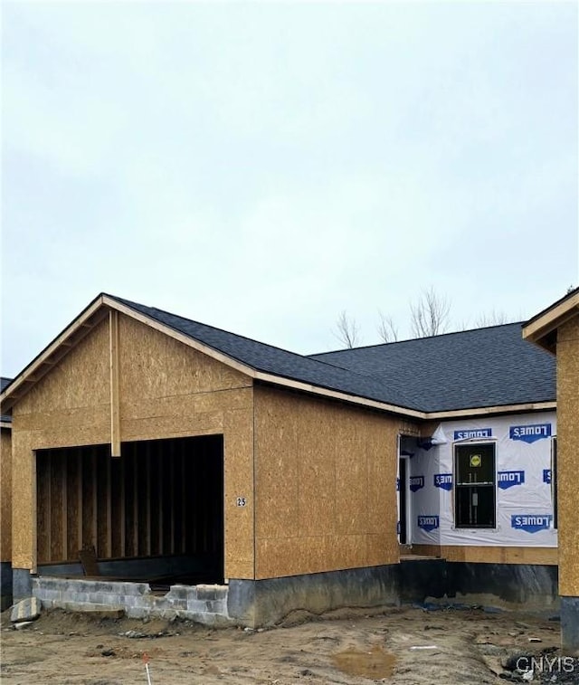 25 Elm St, Schroeppel, NY 13135 - view of side of property with an attached garage and roof with shingles