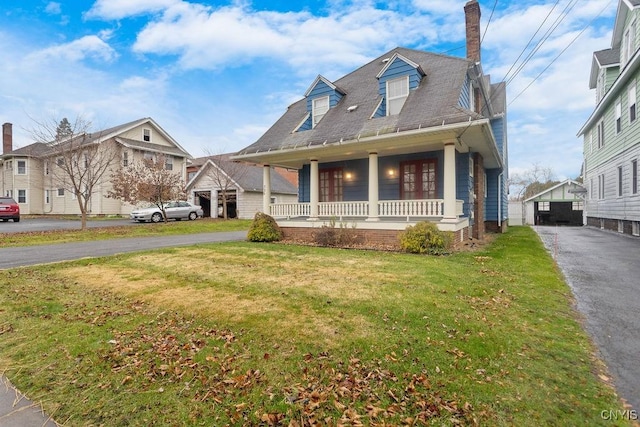 view of front of property with covered porch and a front lawn