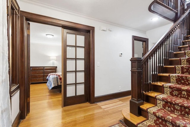 interior space featuring light hardwood / wood-style floors and ornamental molding