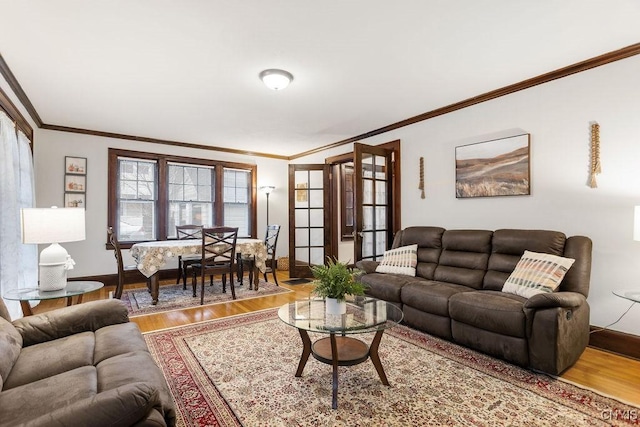 living room with wood-type flooring and crown molding