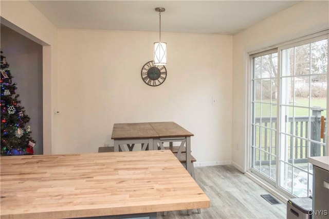 dining area with wood-type flooring