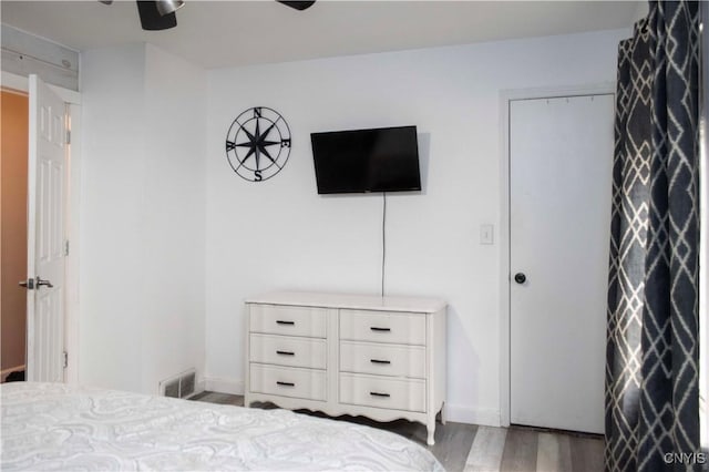 bedroom featuring ceiling fan and dark wood-type flooring