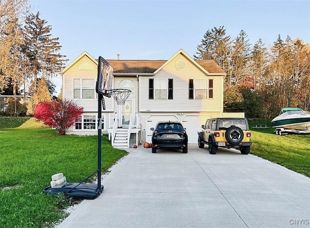 raised ranch featuring a garage and a front yard